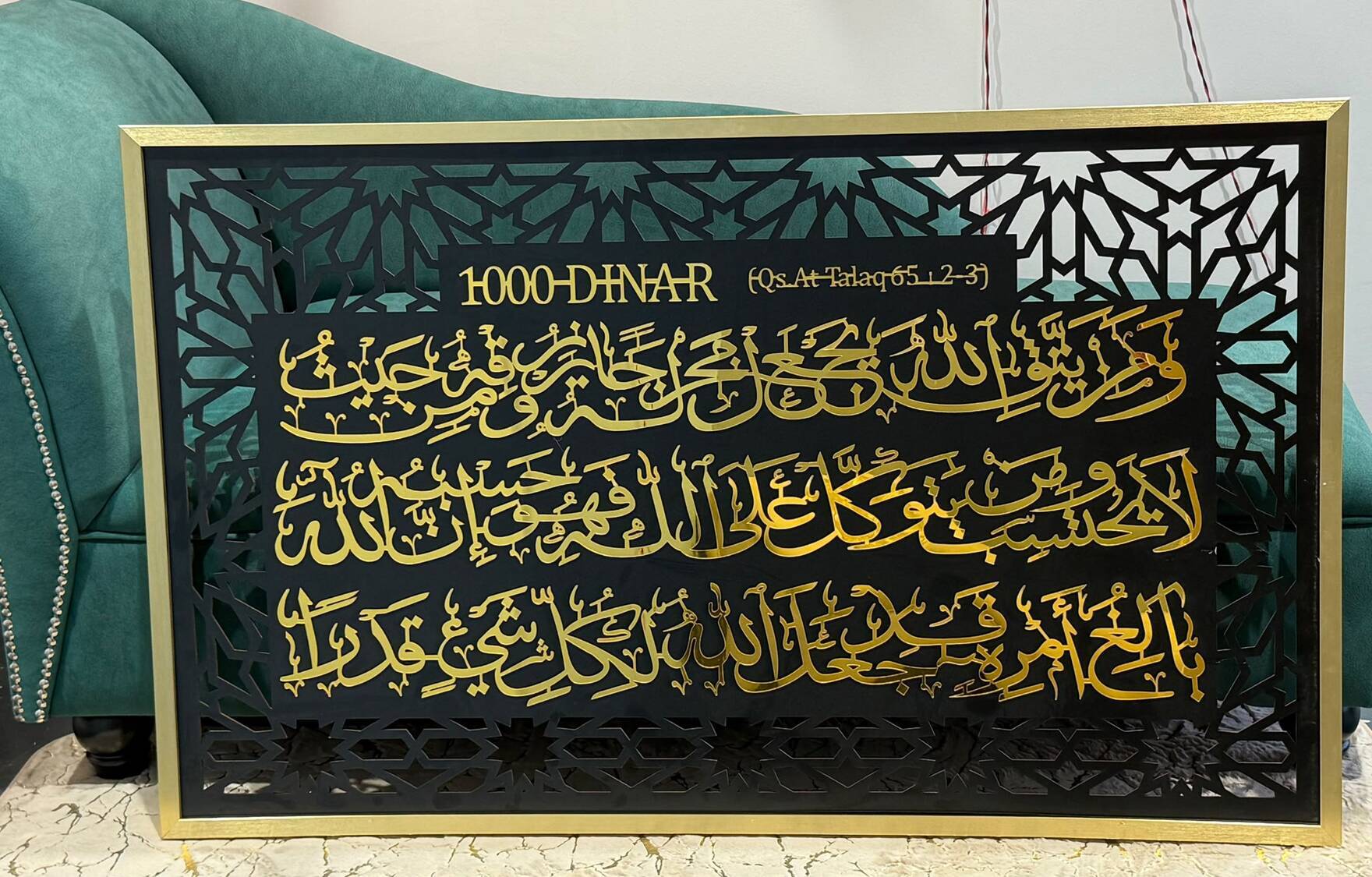 Gold-framed black panel with gold Arabic verse from Surah At-Talaq
